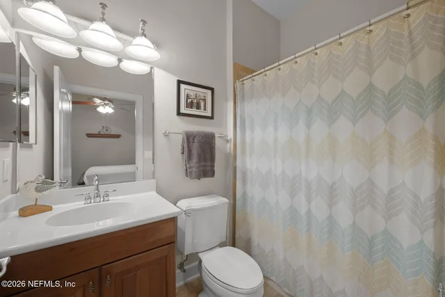 a bathroom with a sink a mirror and a toilet