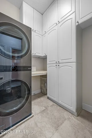 a utility room with wooden floor washer and dryer