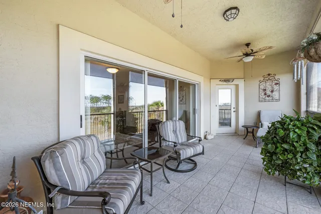 a living room with furniture and a floor to ceiling window