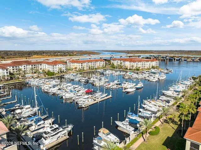 an aerial view of a house with a swimming pool and outdoor seating
