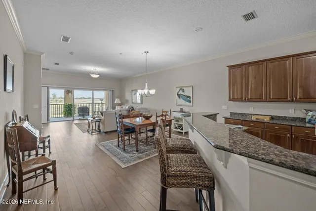 a kitchen with granite countertop lots of counter top space and furniture