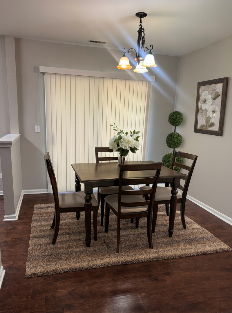 1256 North Split Oak Circle Round Lake Beach, IL 60073 - Photo 4 of 8 a dining room with wooden floor a chandelier a wooden table and chairs