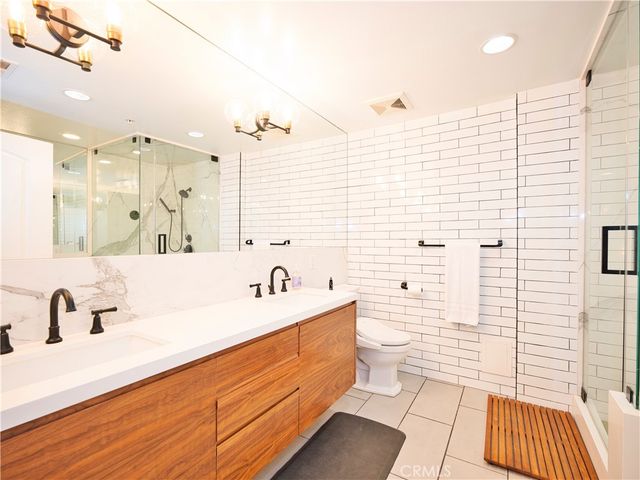 a bathroom with a sink a mirror and a bathtub