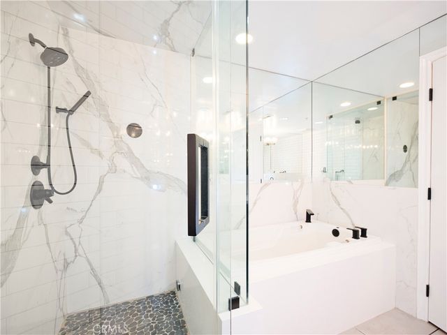 a bathroom with a bathtub and a shower