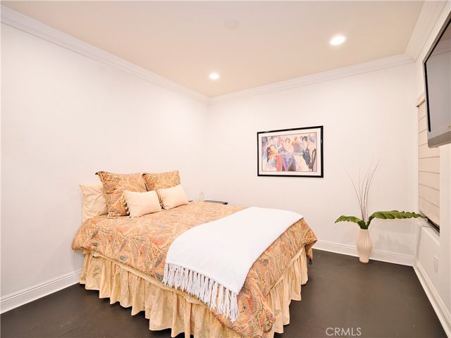 a bedroom with bed and a potted plant