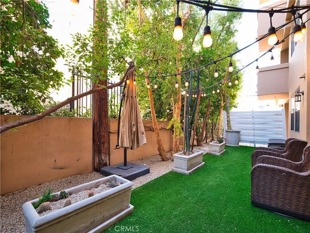 a view of backyard with seating area and trees