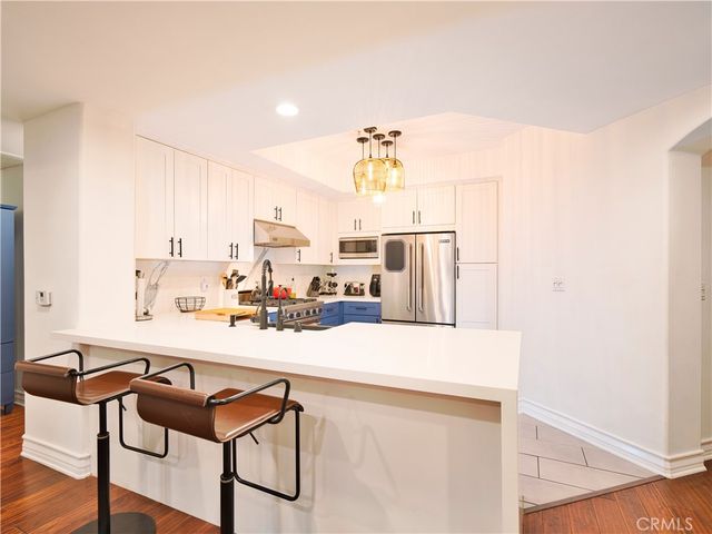 a room with a table chairs and wooden floor