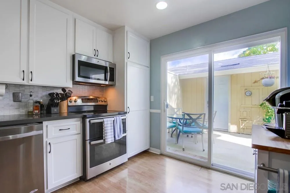 284 Gardendale Road Encinitas, CA 92024 - Photo 25 of 59 a kitchen with granite countertop a stove a sink and a microwave