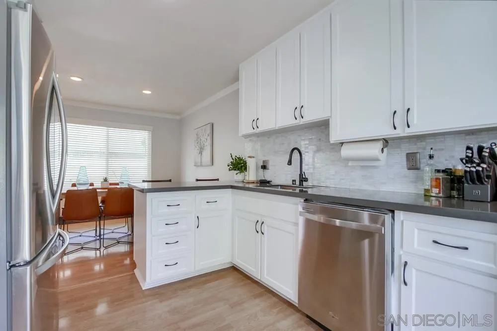 284 Gardendale Road Encinitas, CA 92024 - Photo 29 of 59 a kitchen with stainless steel appliances granite countertop a stove a sink and white cabinets