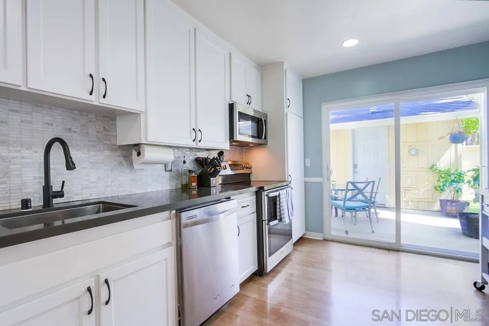 284 Gardendale Road Encinitas, CA 92024 - Photo 30 of 59 a kitchen with granite countertop a sink and a stove top oven