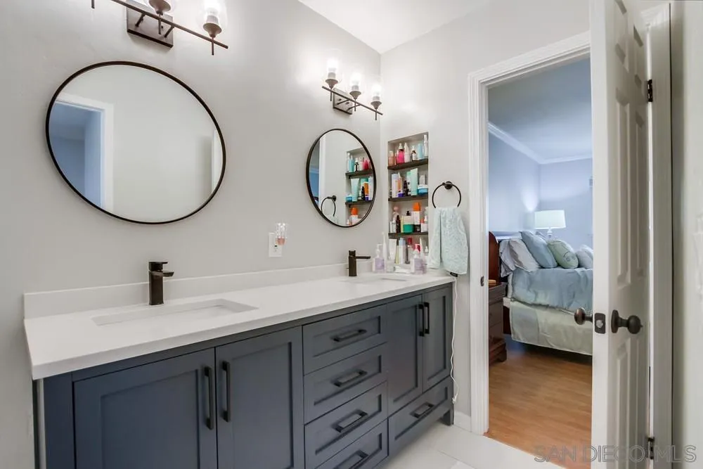 284 Gardendale Road Encinitas, CA 92024 - Photo 39 of 59 a bathroom with a double vanity sink and a mirror