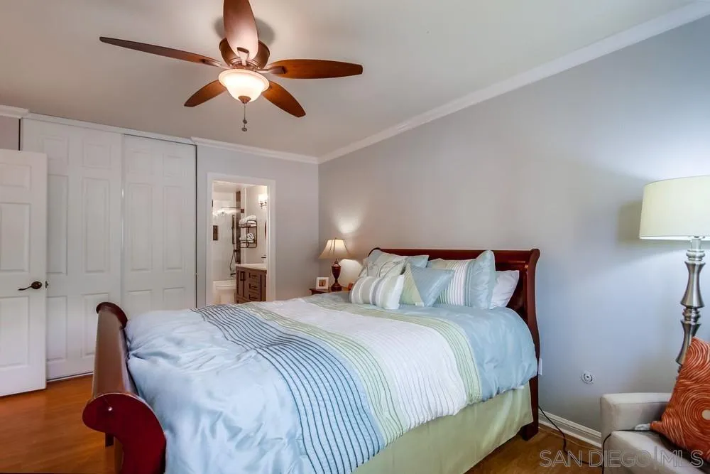 284 Gardendale Road Encinitas, CA 92024 - Photo 46 of 59 a bedroom with a bed and a chandelier