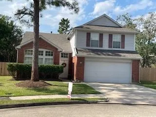 a front view of a house with a yard garage and plants