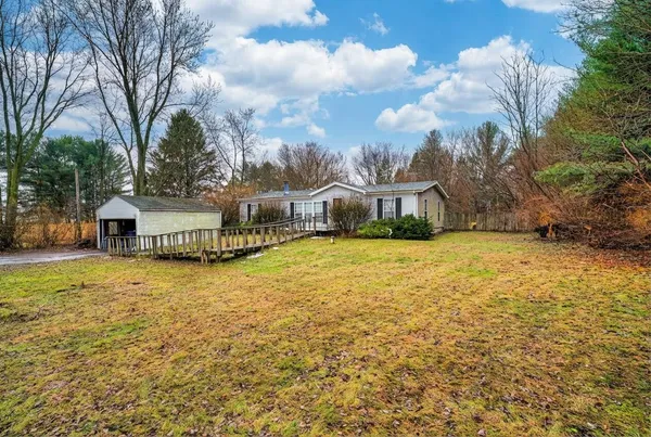 a house view with swimming pool in front of it