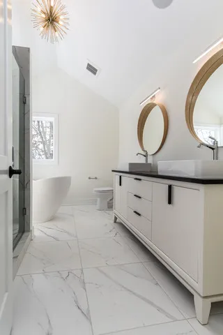 a spacious bathroom with a double vanity sink and a mirror