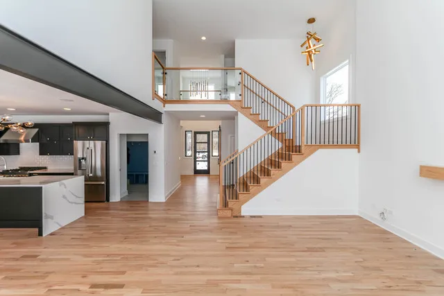 a view of entryway and kitchen with wooden floor