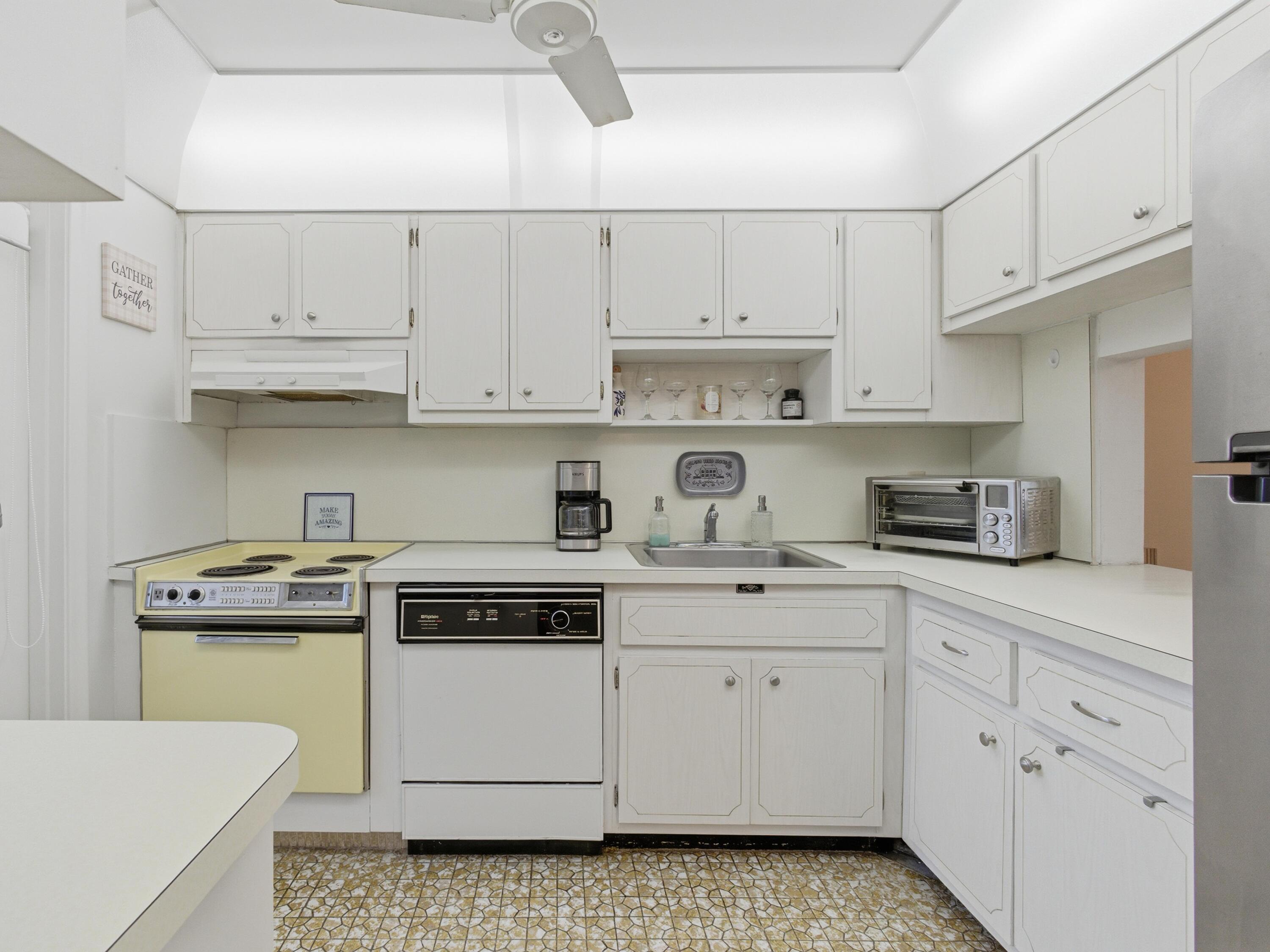 400 Northeast 20th Street, Unit A216 Boca Raton, FL 33431 - Photo 14 of 32 a kitchen with cabinets appliances a sink and a stove