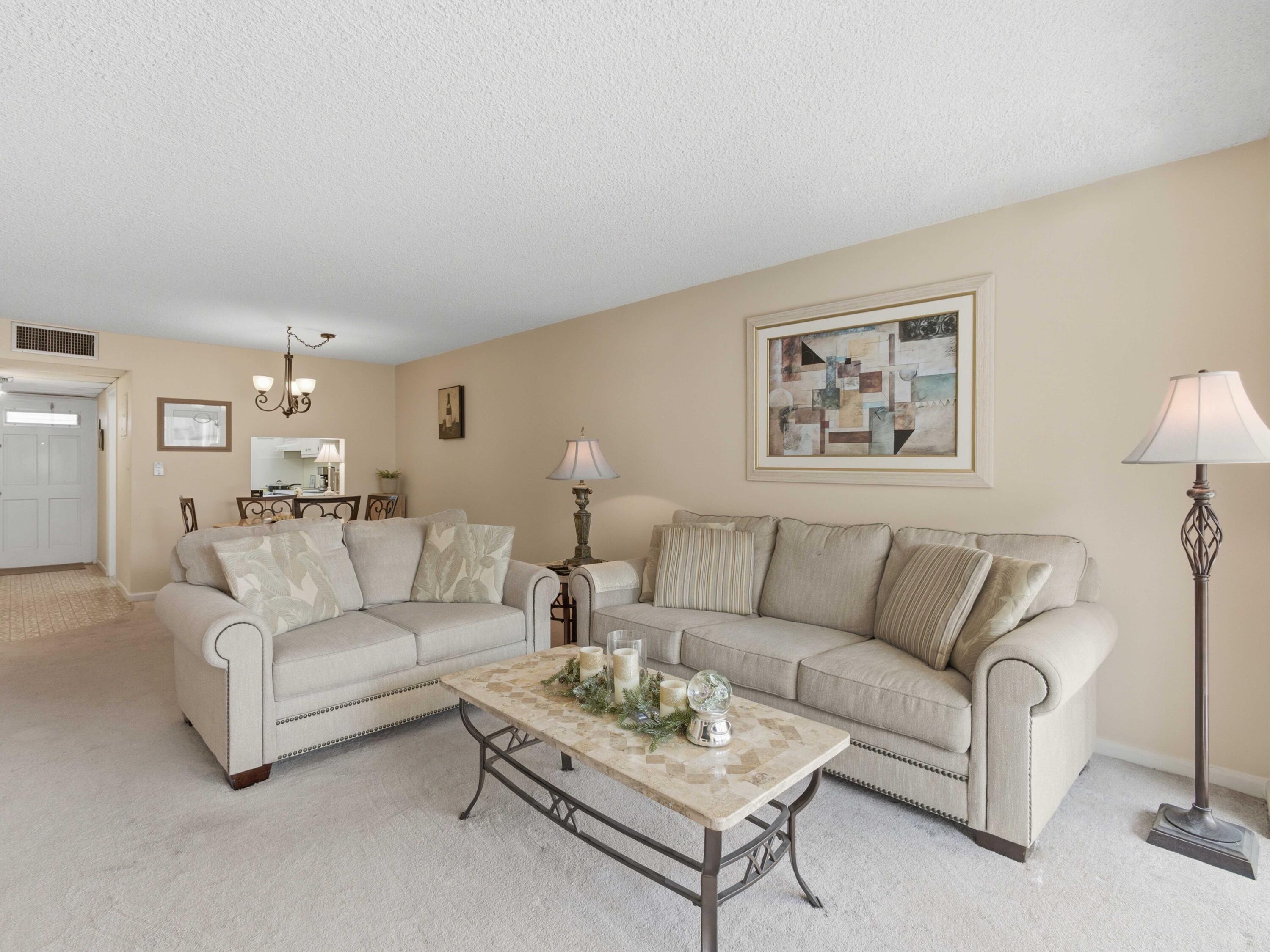 400 Northeast 20th Street, Unit A216 Boca Raton, FL 33431 - Photo 2 of 32 a living room with furniture and a wall painting