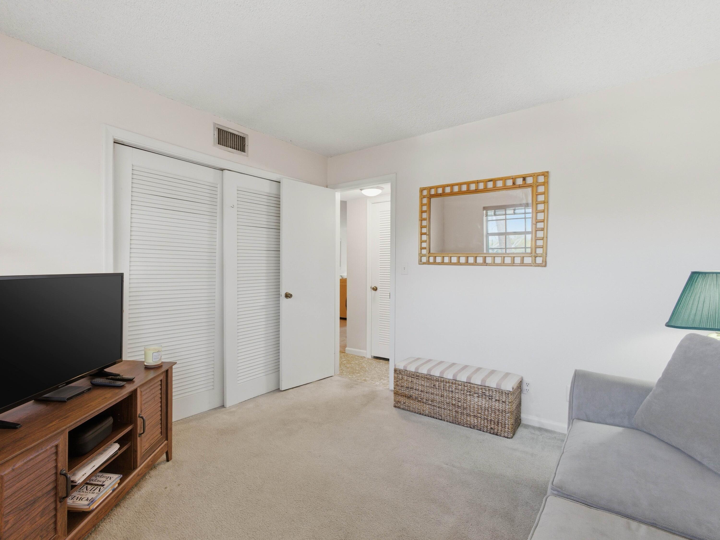 400 Northeast 20th Street, Unit A216 Boca Raton, FL 33431 - Photo 21 of 32 a living room with furniture and a flat screen tv