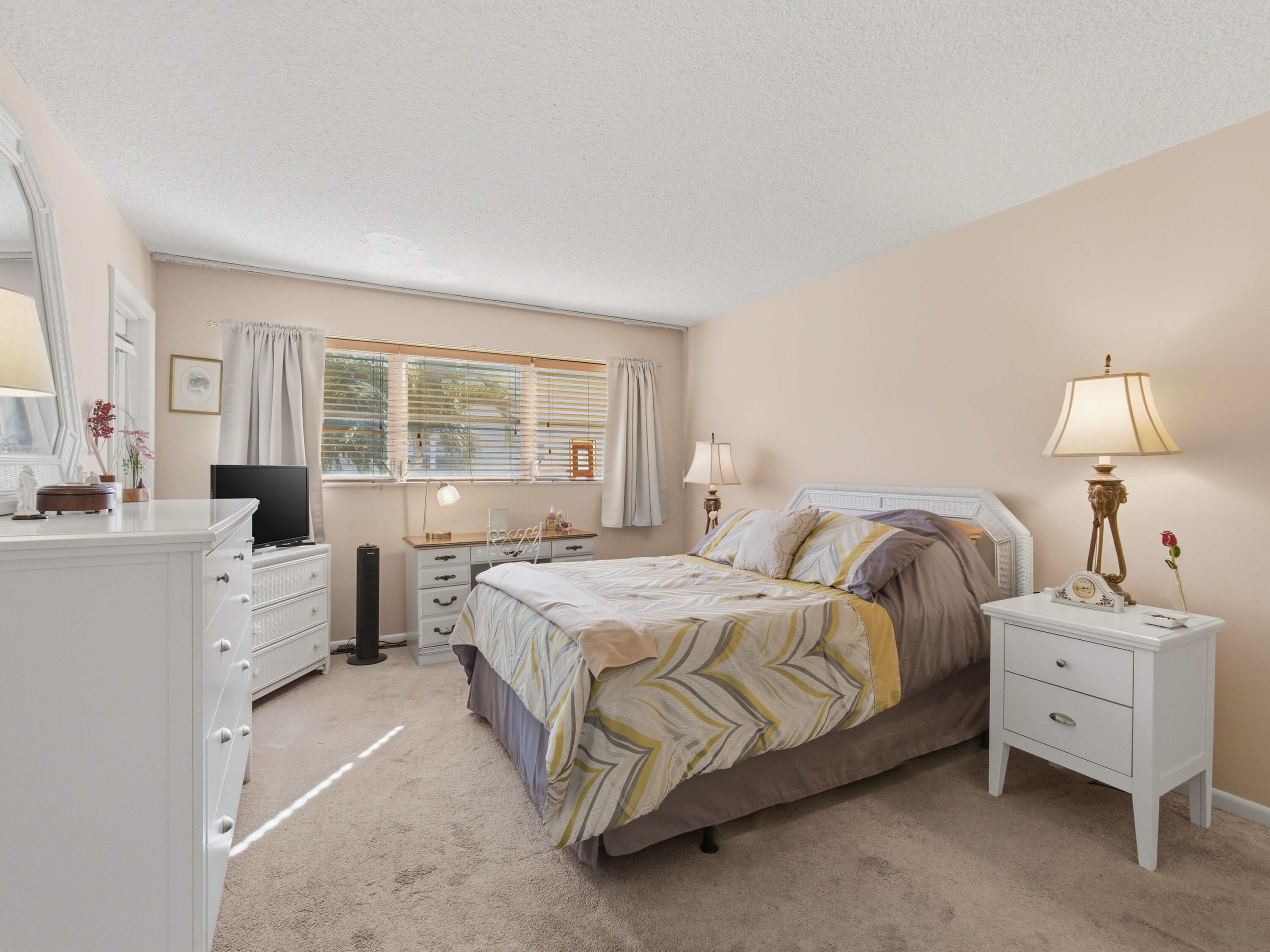 400 Northeast 20th Street, Unit A216 Boca Raton, FL 33431 - Photo 5 of 32 a bedroom with a bed and a large window