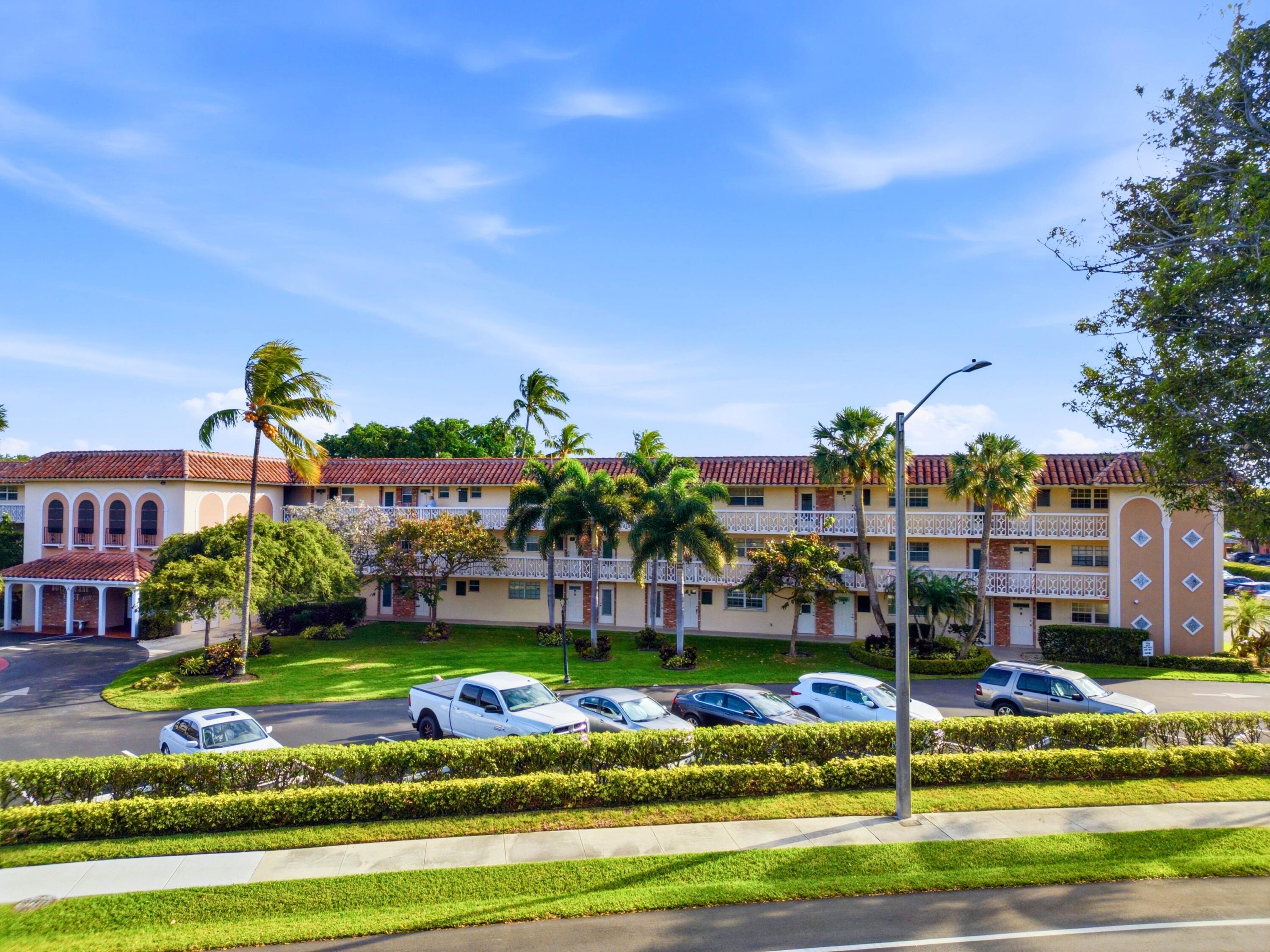 400 Northeast 20th Street, Unit A216 Boca Raton, FL 33431 - Photo 8 of 32 a front view of building with yard