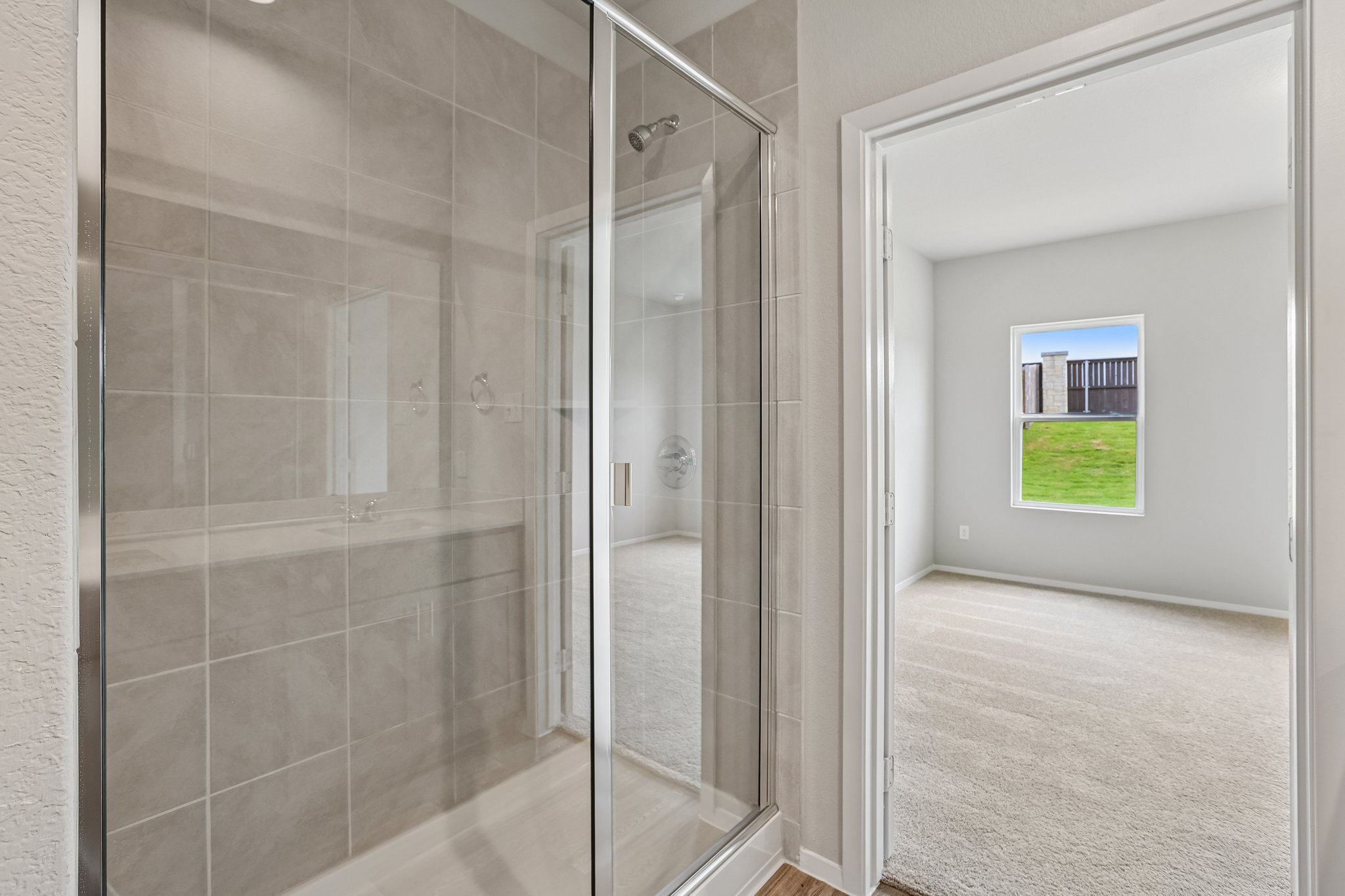 5513 Sacra Cove Austin, TX 78747 - Photo 22 of 37 a bathroom with a shower and a glass door