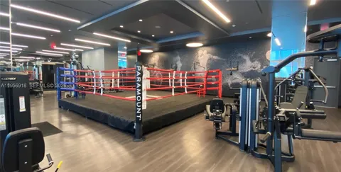 a living room with furniture a rug and a wall painting