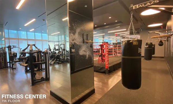 a living room with furniture a rug and a projector