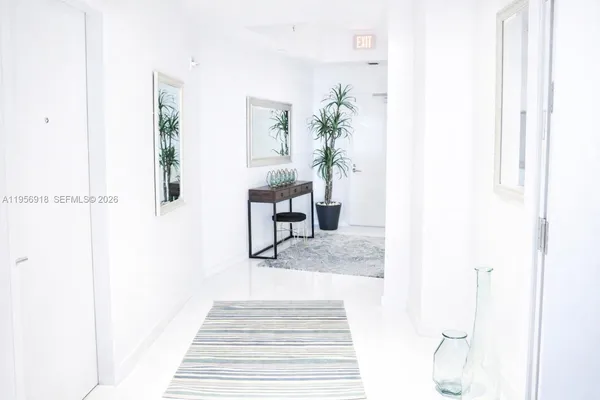 a living room with furniture and a mirror