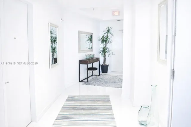 a living room with furniture and a mirror