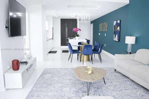 a large bed sitting in a bedroom next to a window