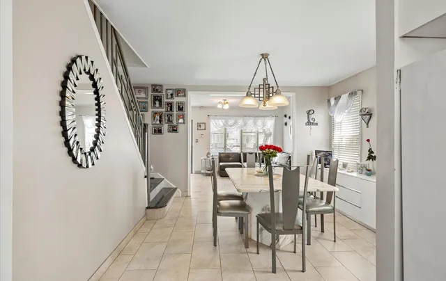 a view of a dining room with furniture and chandelier