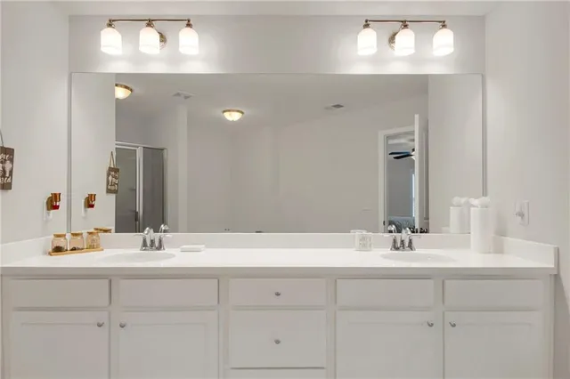 a bathroom with double sink and a mirror