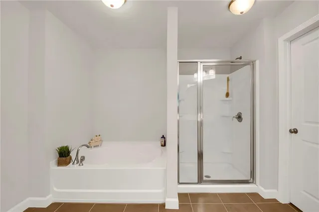 a bathroom with a tub shower and sink