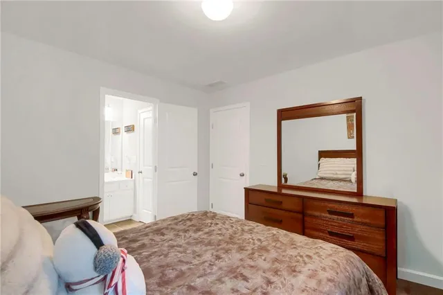a bedroom with a bed and a dresser