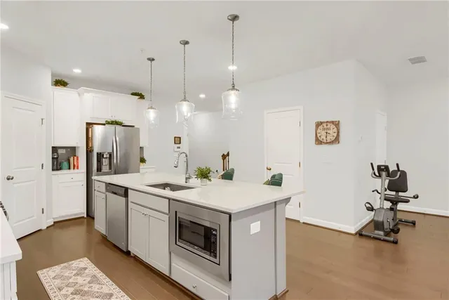 a kitchen with a sink a counter and chairs