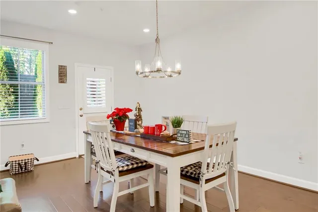 a view of a dining room with furniture and chandelier