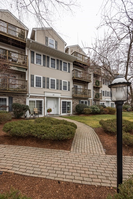 22 Forge Pond, Unit G Canton, MA 02021 - Photo 11 of 13 a front view of a building with garden