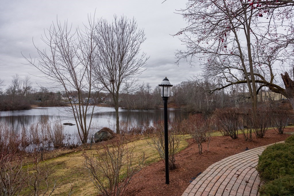 22 Forge Pond, Unit G Canton, MA 02021 - Photo 12 of 13 a lake view with a bench in the middle