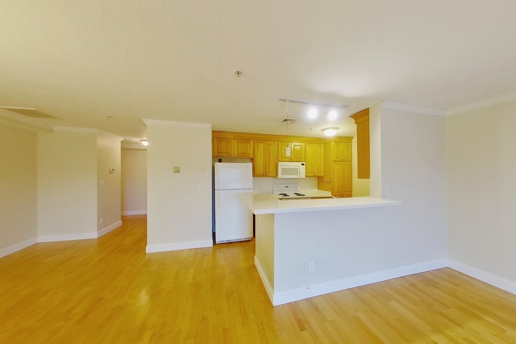 22 Forge Pond, Unit G Canton, MA 02021 - Photo 2 of 13 a view of a kitchen with wooden floor and a sink