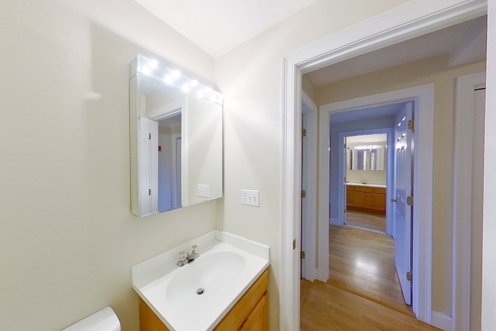 22 Forge Pond, Unit G Canton, MA 02021 - Photo 8 of 13 a bathroom with a sink a mirror and a toilet