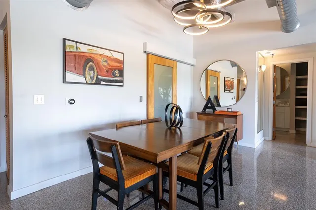 a view of a dining room with furniture and a chandelier