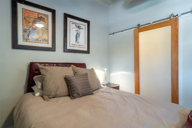 a large bed sitting in a bedroom next to a window