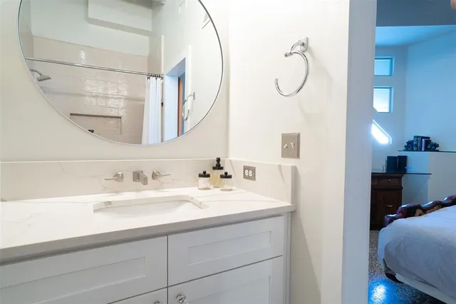 a en suite bathroom with a sink and a mirror