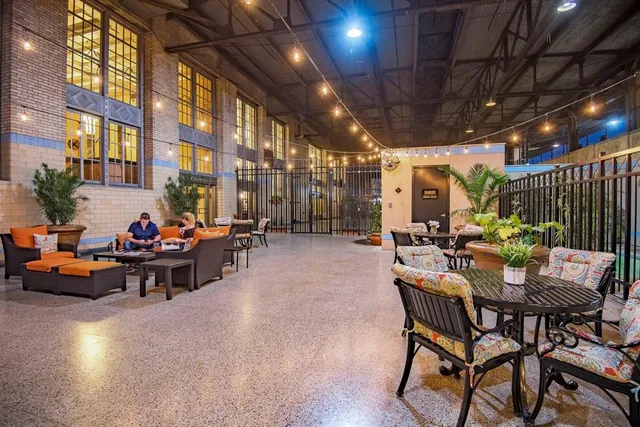 a view of a patio with table and chairs and potted plants
