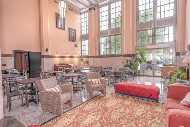 a living room with furniture and large windows