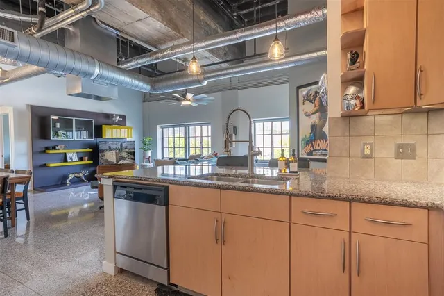 a kitchen with stainless steel appliances granite countertop a sink and cabinets