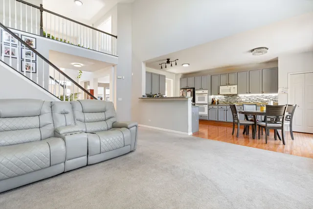 a living room with furniture and a dining table
