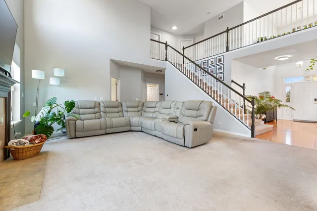 a living room with furniture and stairs