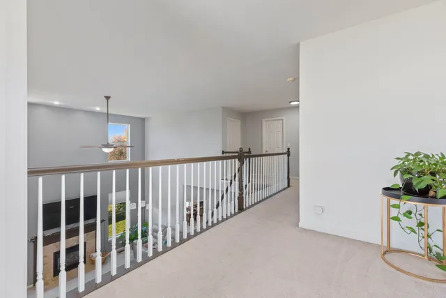 a bedroom with a bed a lamp and a dresser